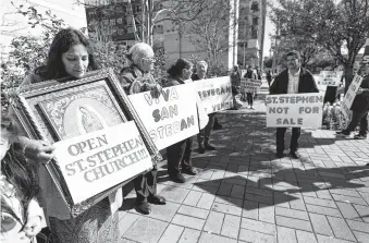  ?? Karen Warren / Staff photograph­er ?? St. Stephen’s parishione­rs protested in front of the Co-Cathedral of the Sacred Heart because the Diocese of Galveston-Houston still hasn’t announced a timeline to reopen their church.