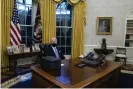  ?? Photograph: Evan Vucci/AP ?? Biden signs his first executive orders in the Oval Office.