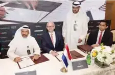  ??  ?? KNPC CEO Mohammad Ghazi Al-Mutairi signs a deal with Atradius.