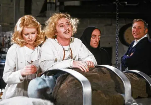  ?? KINO LORBER/ALAMY STOCK PHOTO ?? From left: Teri Garr, Peter Boyle (on table,) Gene Wilder, Marty Feldman, and Mel Brooks on the set of “Young Frankenste­in.”