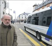  ?? Photograph: Iain Ferguson, The Write Image. ?? Fort William businessma­n Drew Purdon at the bus stop nearest the High Street as a tourist bus braves the ban to drop off passengers.