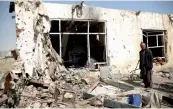  ?? — AP ?? A man looks on as he stands at the site of a suicide car bomb in Kabul on Saturday.