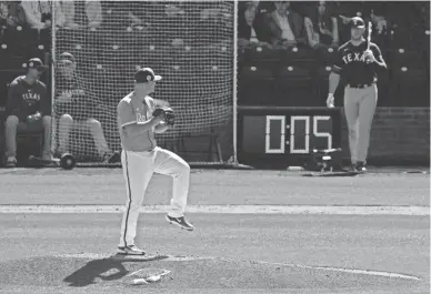  ?? CHARLIE RIEDEL/AP ?? The Royals’ Nick Wittgren throws before the pitch clock runs out during the fifth inning of a spring training game against the Rangers on Friday in Surprise.