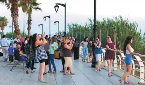  ?? HASSAN AMMAR / ASSOCIATED PRESS ?? Tourists takes pictures in Beirut, Lebanon, which is enjoying a rise in tourism due to unrest and upheaval elsewhere in the Middle East.