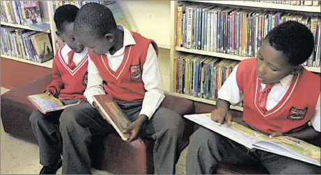  ??  ?? Pupils reading at Eldorado public library.