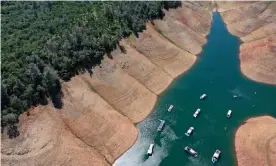  ??  ?? Houseboats are dwarfed by the steep banks of Lake Oroville last month in Oroville, California. Photograph: Justin Sullivan/Getty Images