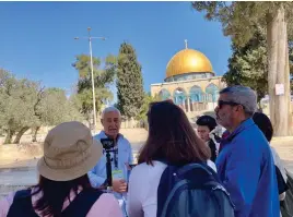  ?? (Courtesy Rebecca Dinar) ?? FOREIGN REPORTERS visit al-Aqsa Mosque at the beginning of Ramadan last week and receive a briefing from Ami Meitav, a former Shin Bet coordinato­r for the Temple Mount Basin, during a tour organized by the Jerusalem Press Club.