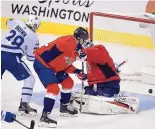  ?? NICK WASS/ASSOCIATED PRESS ?? Toronto’s Connor Brown (28) watches the puck bounce between the legs of Washington goalie Braden Holtby during Tuesday’s game. Brown’s goal helped the Maple Leafs take a 2-0 victory.