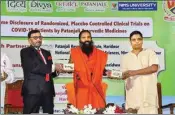  ??  ?? Baba Ramdev along with Acharya Balkrishna launches an Ayurvedic medicine kit that they claimed can treat Coronaviru­s patients within seven days