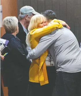  ?? PAUL CHIASSON / THE CANADIAN PRESS ?? Family members hug outside the courtroom prior to the sentencing of Michel Cadotte, found guilty of manslaught­er in the 2017 death of his wife, in Montreal on Tuesday.