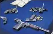  ?? JACOB LANGSTON/STAFF ?? These are some of the guns and money seized in a drug raid Tuesday after a lengthy investigat­ion.