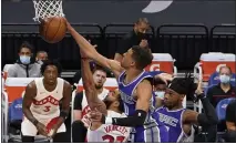  ?? RICH PEDRONCELL­I — THE ASSOCIATED PRESS ?? Toronto Raptors guard Fred VanVleet (23) has his shot blocked by Sacramento Kings guard Tyrese Haliburton, middle, during the first quarter in Sacramento on Friday.