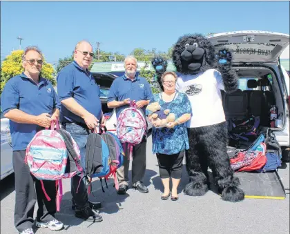  ?? BETH PENNEY/THE TELEGRAM ?? Elaine Balsom, executive director of the Single Parent Associatio­n of Newfoundla­nd, accepted a donation of 100 book bags and supplies from Newfound Cabs Monday in St. John’s. Shown here (from left) are Harvey, Newfound Cab’s manager Derek Hayter, Bob...