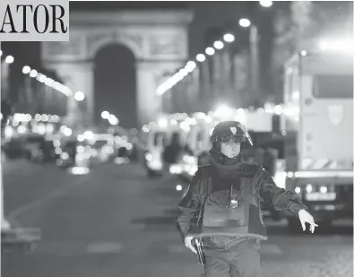  ?? THIBAULT CAMUS / THE ASSOCIATED PRESS ?? A police officer in Paris stands guard after a gunman opened fire on fellow officers with an automatic weapon on the Champs-Elysees, an area popular with tourists, on Thursday, killing one officer and injuring several others.