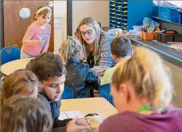  ?? Paul Buckowski / Times Union ?? Kayla Claus, foreground, a teaching assistant, and kindergart­en teacher Nikki Wagner, background, work with students in their literacy pods at the Heatly School on April 28 in Green Island. Capital Region school districts are not reporting a teacher shortage as fall classes approach, as other schools have experience­d nationwide.