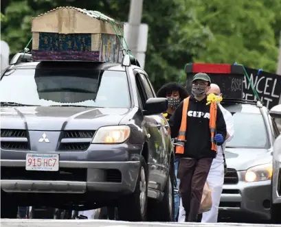  ??  ?? LIFE-AND-DEATH MATTER: Protesters arrive with mock coffins to protest the state’s handling of the COVID-19 pandemic for people of color.