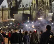  ??  ?? Mob: Gangs gather in Cologne on New Year’s Eve