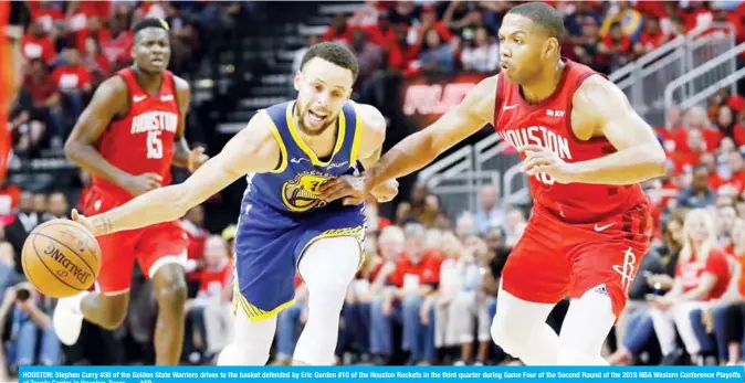  ??  ?? HOUSTON: Stephen Curry #30 of the Golden State Warriors drives to the basket defended by Eric Gordon #10 of the Houston Rockets in the third quarter during Game Four of the Second Round of the 2019 NBA Western Conference Playoffs at Toyota Center in Houston, Texas. — AFP