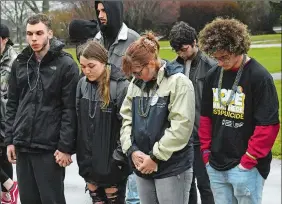  ?? DANA JENSEN/THE DAY ?? Attendees participat­e in a moment of silence Saturday on the Mitchell College campus in New London before the Out of the Darkness walk for suicide prevention.