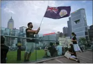  ?? VINCENT YU — THE ASSOCIATED PRESS FILE ?? A protester waves Hong Kong British colony flag on Sept. 3, 2019during continuing pro-democracy rallies in Tamar Park, Hong Kong.