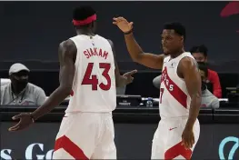  ?? CHRIS O’MEARA — THE ASSOCIATED PRESS ?? Raptors guard Kyle Lowry celebrates with forward Pascal Siakam (43) as the pair is taken out of the game against the Nuggets on Wednesday in Tampa, Fla.