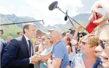  ?? — Reuters ?? French President Emmanuel Macron greets people as he arrives to visit the Pic du Midi in the Pyrenees mountains France, on Thursday.