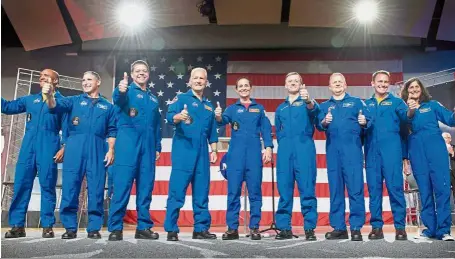  ?? — AFP ?? Dream team: Victor Glover, Mike Hopkins, Bob Behnken, Doug Hurley, Mann, Ferguson, Boe, Josh Cassada, and Suni Williamson waving after being announced as the first US astronauts who will fly on American-made, commercial spacecraft to and from the Internatio­nal Space Station at Nasa’s Johnson Space Center in Houston, Texas.