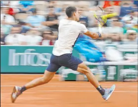  ?? Jean-francois Badias The Associated Press ?? Spain’s Carlos Alcaraz volleys to Albert Ramos-vinolas during their second-round match Wednesday at the French Open.
