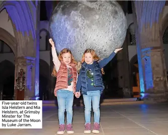  ?? ?? Five-year-old twins Isla Helstern and Mia Helstern, at Grimsby Minster for The Museum of the Moon by Luke Jarram.