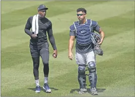  ?? KATHY WILLENS — THE ASSOCIATED PRESS ?? Yankees relief pitcher Aroldis Chapman, left, leaves the field after a bullpen session with catcher Gary Sanchez last week. Chapman has tested positive for Covid-19.