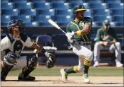  ?? STEPH CHAMBERS — GETTY IMAGES ?? The A’s Tony Kemp singles against the Milwaukee Brewers to lead off Tuesday’s spring training game at American Family Fields of Phoenix. Kemp went on to steal second and score in Oakland’s 2-1victory.