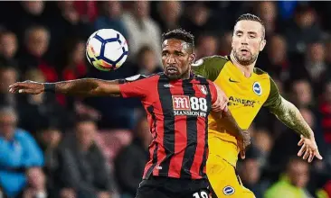  ??  ?? Well covered: Bournemout­h’s Jermain Defoe shielding the ball from Brighton’s Shane Duffy during the match on Friday. — AFP