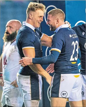  ??  ?? Finn Russell (right) celebrates one of Scotland’s eight tries against Georgia with scorer, Duhan van der Merwe