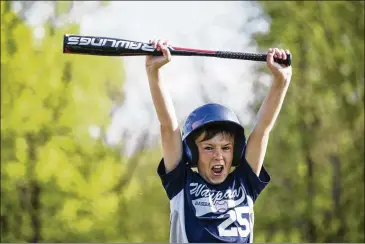  ??  ?? Ryder Vergauwen, 10, yells after hitting a home run while holding a new USA Baseball-approved bat in Waupaca, Wis. Millions of youth baseball players were forced to dig deep into their (or their parents’) pockets for bats stamped with the USA Baseball...