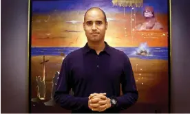  ?? Photograph: Rex Features ?? Saif al-Islam Gaddafi in 2002, standing in front of a painting that features an image of his father, Muammar Gaddafi, in the top right hand corner.