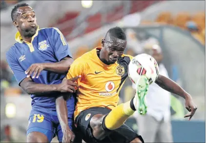  ?? PHOTO: ANTONIO MUCHAVE ?? NO WAYS: Kaizer Chiefs ’ Mulomowand­au Mathoho fights for the ball with Louis Jerome of Township Rollers during their CAF Champions League match at FNB Stadium on Saturday