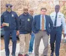  ?? ULYSSES MUNOZ/BALTIMORE SUN ?? Officials make their way to the news conference area to describe the circumstan­ces under which a man entered Douglass High and shot an employee.