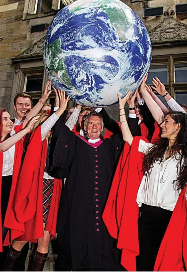  ??  ?? Global reach: Michael Palin celebratin­g with students at St Andrews yesterday