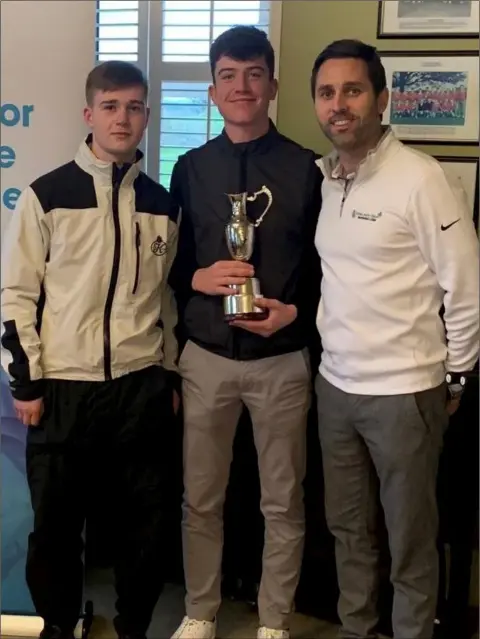  ??  ?? Dylan Keating (Seapoint) holds the winner’s trophy after the first Flogas Irish Junior Open Series event of 2019 at Baltray.
