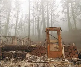  ?? Mel Melcon Los Angeles Times ?? A DOOR is left standing from a clinic in Greenville, Calif. The Dixie fire has consumed at least 1,045 structures, officials say. More than 550 of those were homes.
