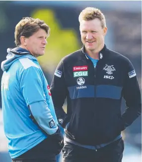  ?? REPRIEVE: Magpies coach Nathan Buckley speaks to assistant coach Robert Harvey. ??