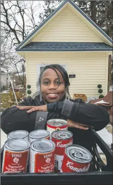  ??  ?? LaMarr-Murphy pauses outside what she calls her she-shed, where she stores equipment for the food pantry.