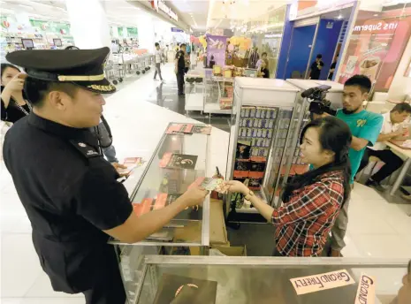  ?? (SUN.STAR FOTO/ALEX BADAYOS) ?? FIREWORKS. Talisay City Fire Marshal Randy Mendaros visits a mall and distribute­s flyers on how to safely handle fireworks.