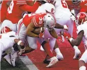  ?? JAY LAPRETE AP ?? Running back Master Teague (center) gives Ohio State a 21-7 lead with his second TD of the game.