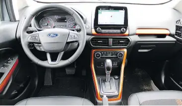  ??  ?? The 2018 Ford EcoSport’s SES trim comes with orange interior highlights, partial leather seats, an eight-inch touchscree­n with navigation and seven-speaker audio.