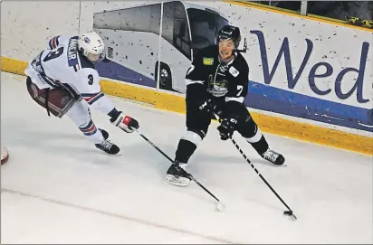  ?? JASON SIMMONDS/JOURNAL PIONEER ?? Dieppe Commandos forward Sam Jay of Freetown, P.E.I., looks to keep the puck away from Summerside D. Alex MacDonald Ford Western Capitals defenceman Jesse Annear. The action took place during the first period of Sunday night’s MHL (Maritime Junior...