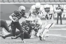  ?? BRANDON HARDER ?? Victor St. Pierre-Laviolette, left, rushes for some of the 169 yards he gained Sunday against the visiting Calgary Colts.