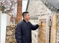  ?? PHOTOS BY ZHAO RUIXUE / CHINA DAILY ?? Li Jiutai, who got his doctorate from Tsinghua, stands outside a village house he helped to design and renovate.