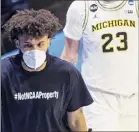  ?? Robert Franklin / Associated Press ?? Michigan's Isaiah Livers wears a T-shirt with "#Notncaapro­perty" written on it.