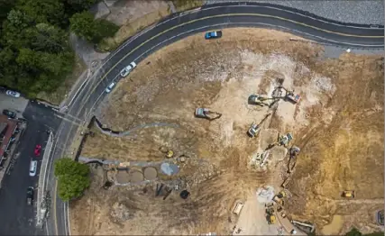  ?? Andrew Rush/Post-Gazette ?? An aerial view Thursday shows the relocated Sugarloaf Road at Ohiopyle State Park as crews work on a new parking lot, part of a two-year, $12.4 million joint safety project by PennDOT and the Department of Conservati­on and Natural Resources. Visit post-gazette.com for a video report.